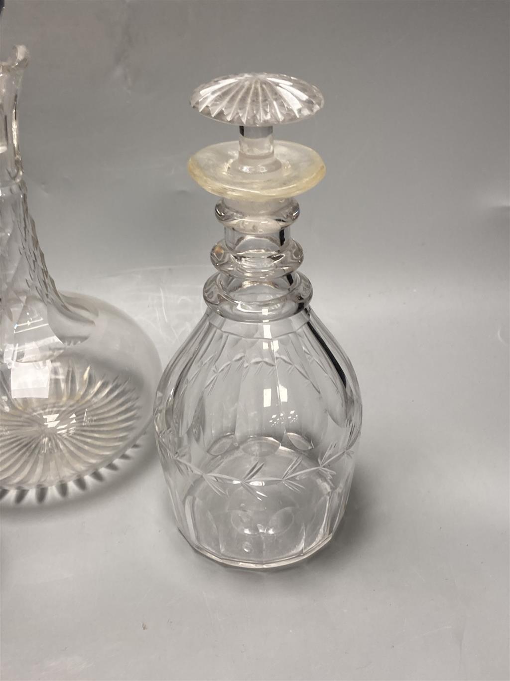 A pair of early 19th century cut glass decanters, height 24cm and an Edwardian claret jug, height 30cm (one decanter a.f.)